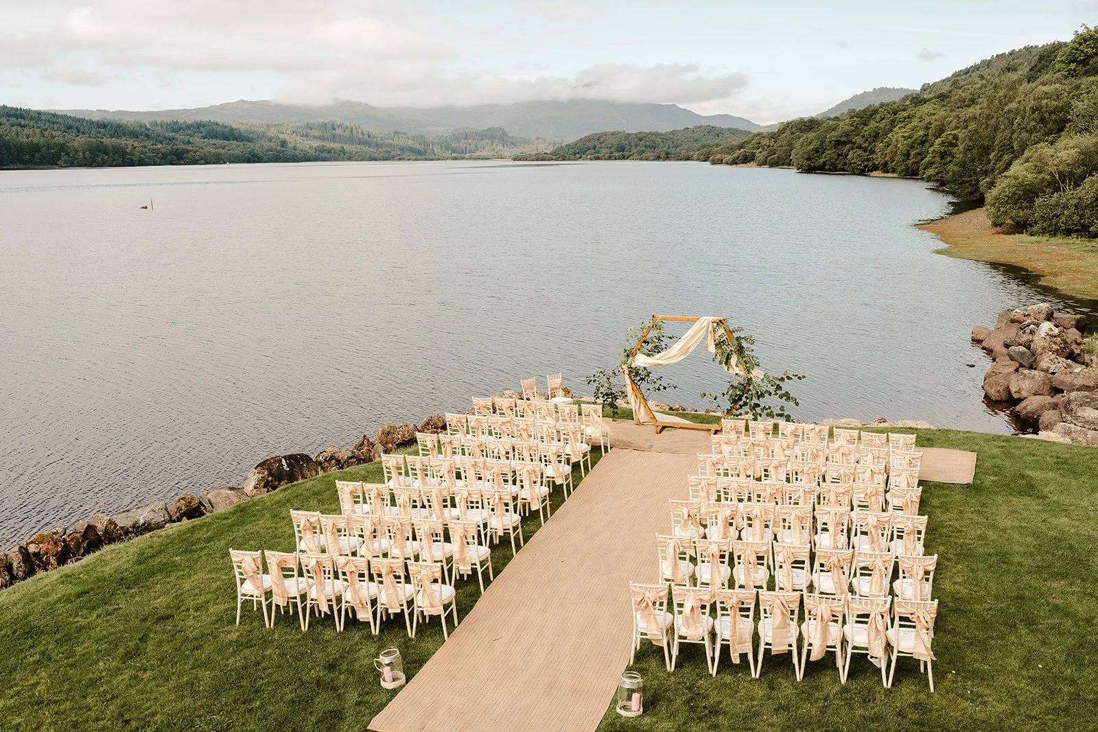 Lochside lawn set with chairs and the hexagonal arch before the ceremony