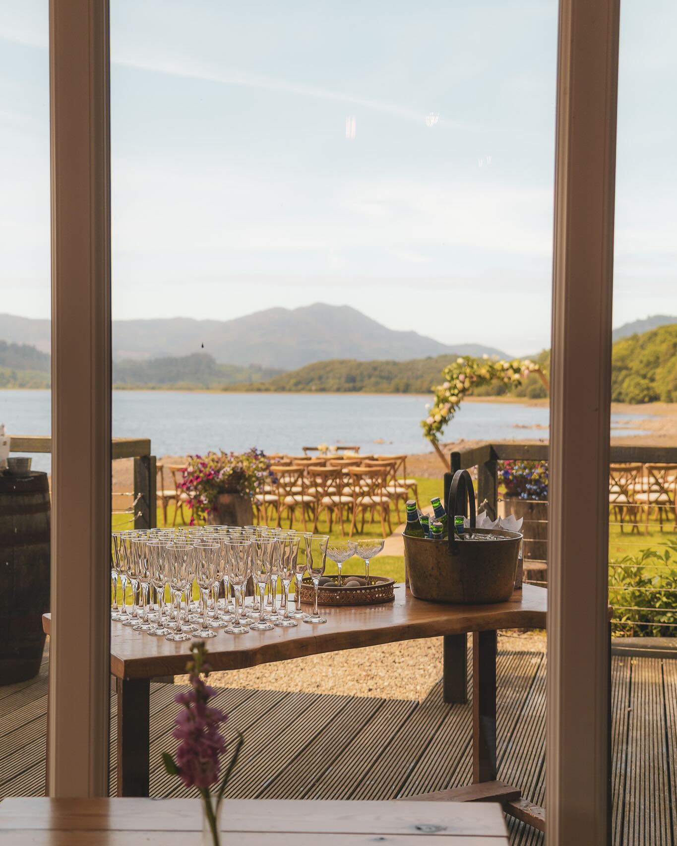 Champagne poured ready for guests, with the lochside ceremony beyond