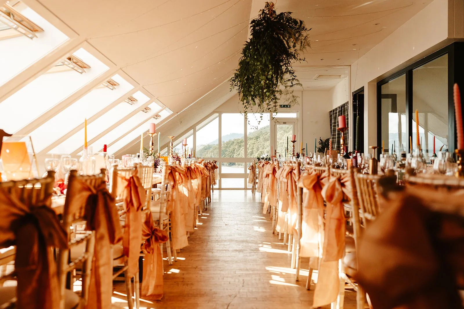 Long wedding breakfast tables set upstairs overlooking the loch